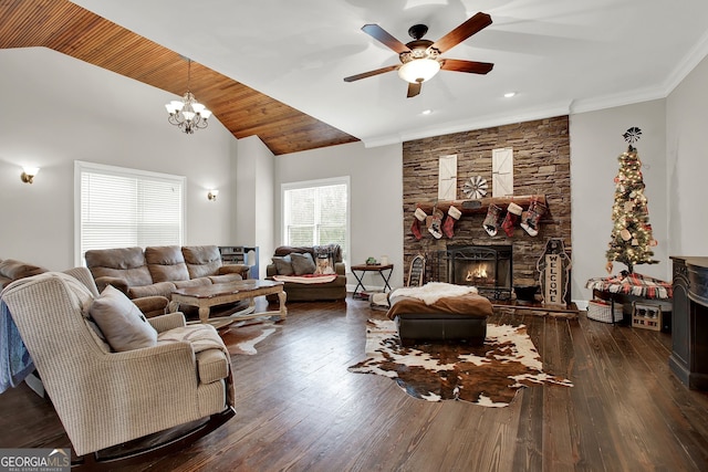 living room with dark hardwood / wood-style flooring, a fireplace, ceiling fan with notable chandelier, and ornamental molding