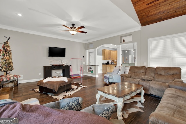 living room featuring vaulted ceiling, ceiling fan, dark wood-type flooring, and crown molding