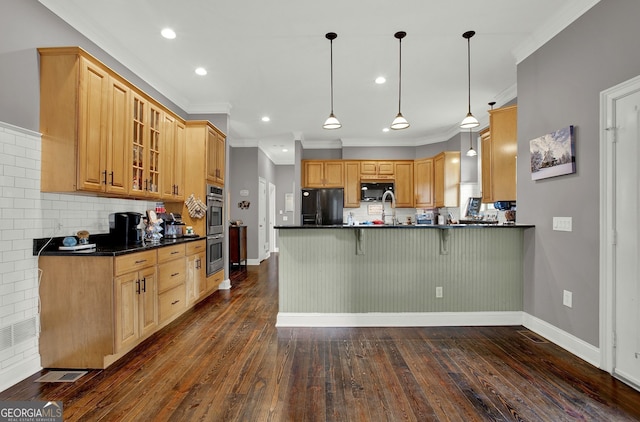 kitchen with backsplash, ornamental molding, black appliances, dark hardwood / wood-style floors, and hanging light fixtures