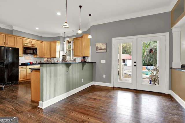 kitchen featuring french doors, black appliances, dark hardwood / wood-style floors, ornamental molding, and decorative light fixtures