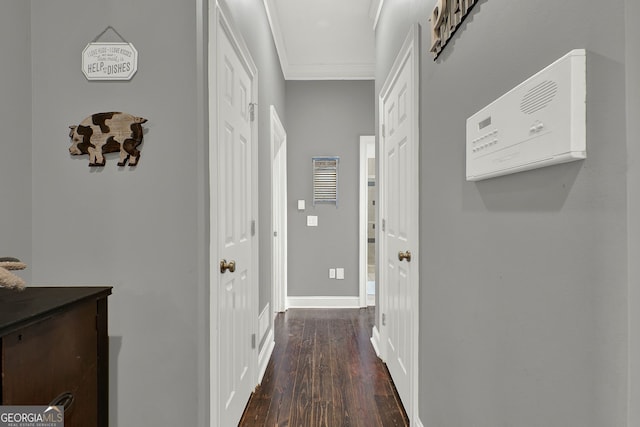 hallway featuring dark hardwood / wood-style flooring and ornamental molding