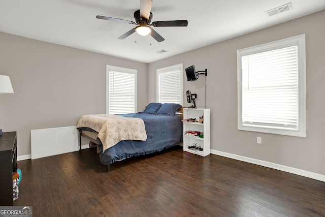 bedroom with ceiling fan and dark wood-type flooring