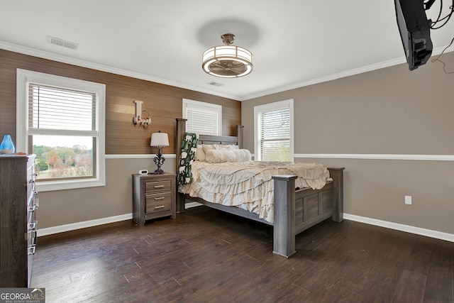 bedroom with dark hardwood / wood-style flooring and crown molding