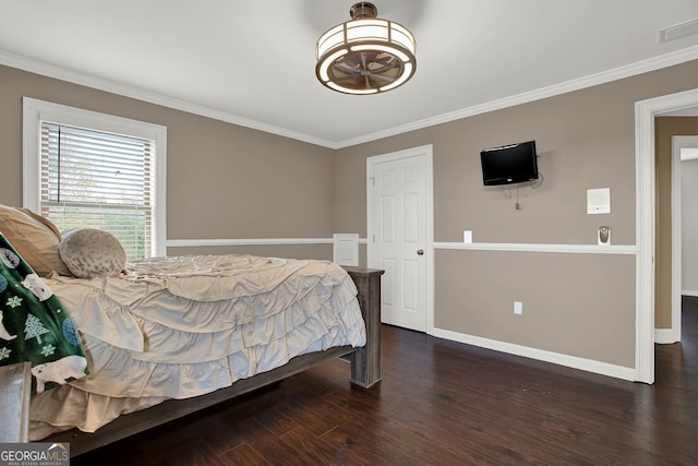 bedroom with dark hardwood / wood-style floors and crown molding