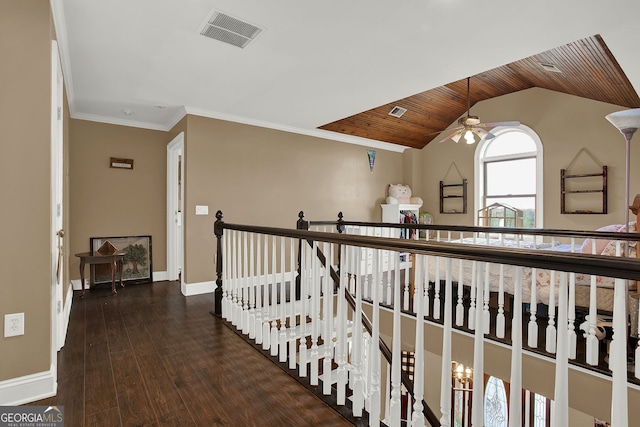 hall featuring dark hardwood / wood-style flooring, lofted ceiling, ornamental molding, and wood ceiling