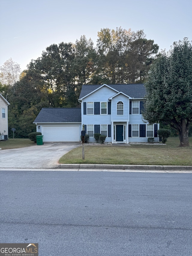 view of front facade with a garage and a front yard