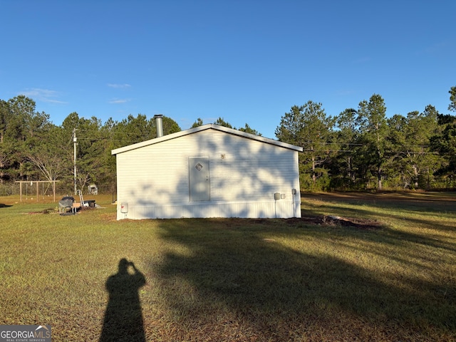 view of home's exterior with a yard