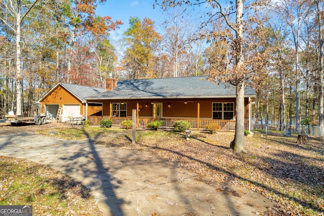 single story home featuring a porch and a garage