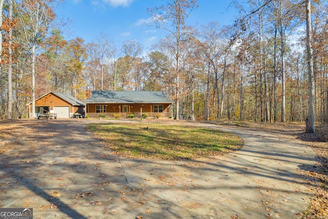 view of front of property featuring a garage and an outdoor structure