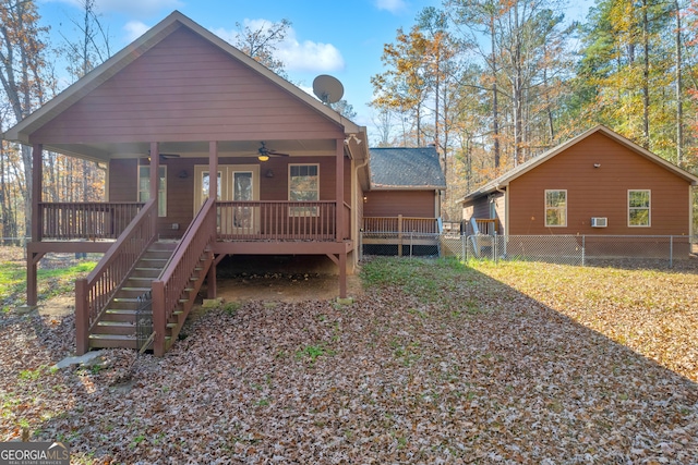 rear view of property featuring covered porch and ceiling fan