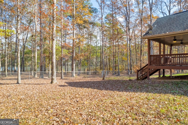 view of yard featuring ceiling fan and a deck