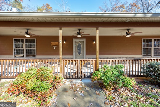 doorway to property featuring covered porch and ceiling fan