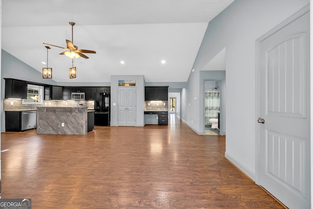 unfurnished living room with ceiling fan, lofted ceiling, and dark wood-type flooring