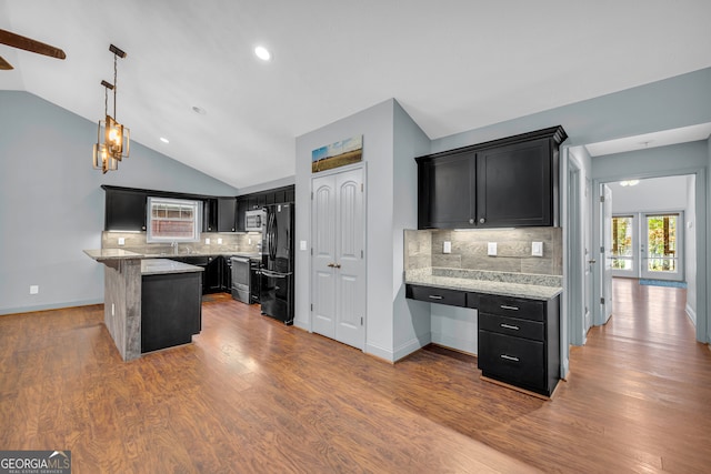 kitchen featuring dark hardwood / wood-style floors, tasteful backsplash, and vaulted ceiling