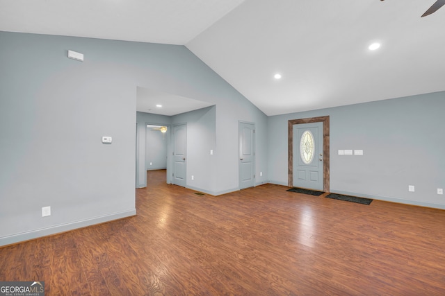 foyer entrance featuring hardwood / wood-style flooring, ceiling fan, and lofted ceiling