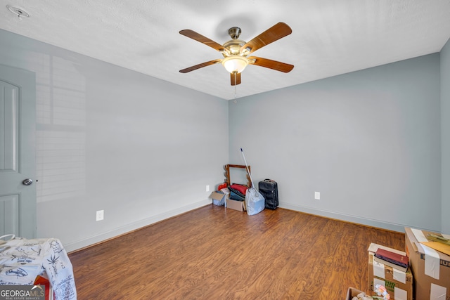 misc room featuring hardwood / wood-style floors, a textured ceiling, and ceiling fan