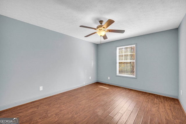 unfurnished room featuring ceiling fan, hardwood / wood-style floors, and a textured ceiling