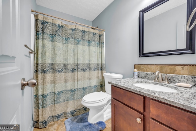 bathroom featuring vanity, tile patterned floors, a textured ceiling, and toilet