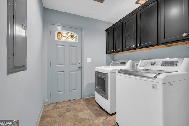 clothes washing area with washing machine and clothes dryer, electric panel, and cabinets