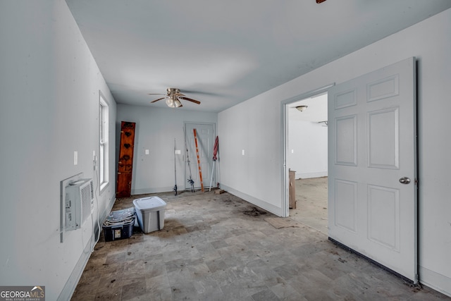 unfurnished living room featuring a wall mounted AC and ceiling fan