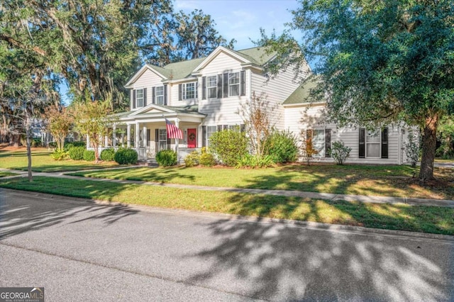 view of front of property with covered porch and a front yard