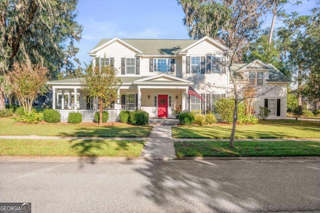 view of front facade with a front lawn and covered porch