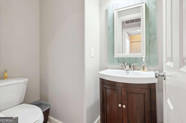 bathroom featuring vanity and toilet