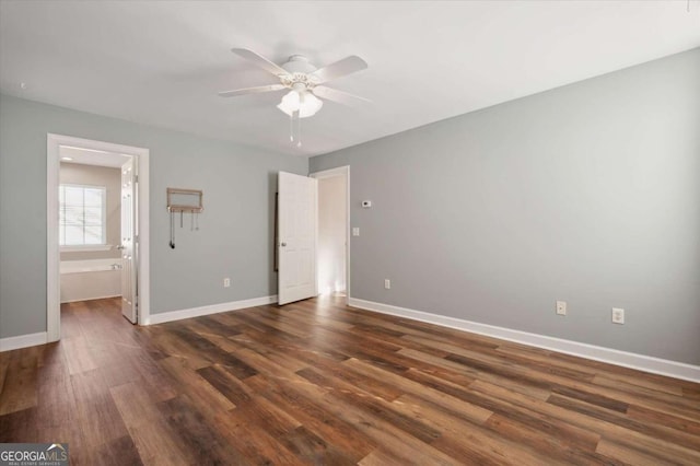 unfurnished bedroom featuring dark hardwood / wood-style flooring, ensuite bath, and ceiling fan