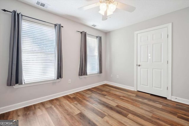 spare room featuring a textured ceiling, hardwood / wood-style flooring, and ceiling fan