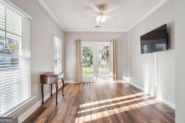 interior space with ceiling fan, dark hardwood / wood-style flooring, and ornamental molding