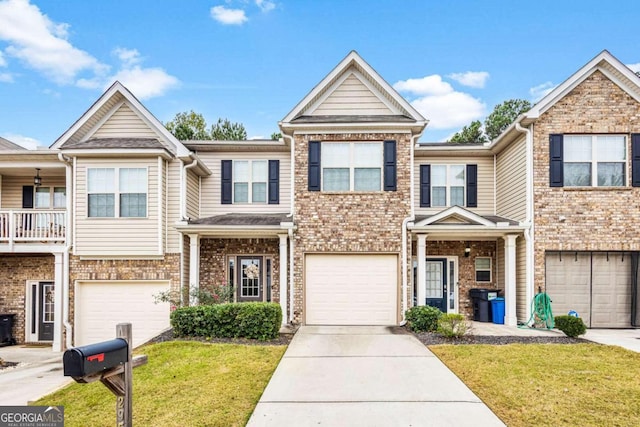 view of property featuring a front yard and a garage