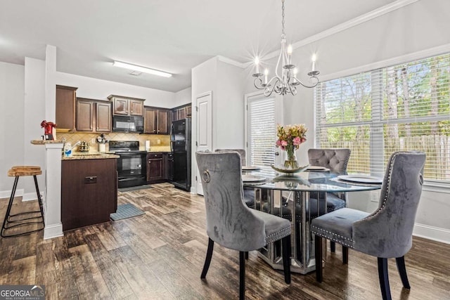 dining room with ornamental molding, dark wood-type flooring, and a chandelier