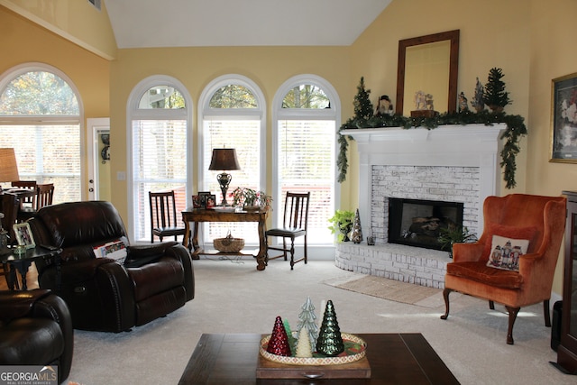 carpeted living room with a fireplace, a wealth of natural light, and vaulted ceiling