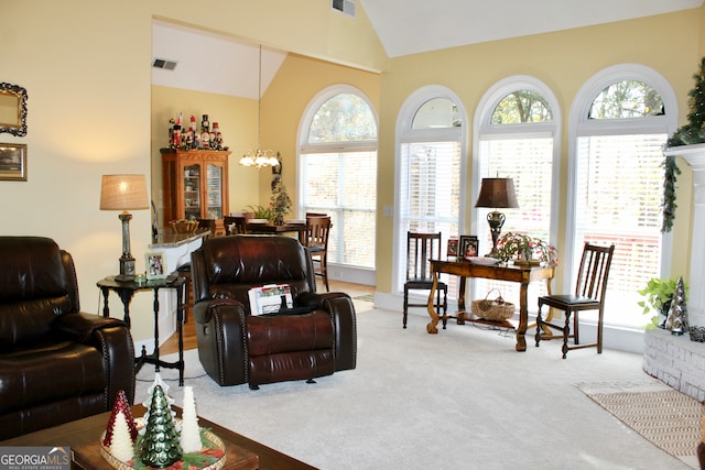 carpeted living room with a chandelier and vaulted ceiling