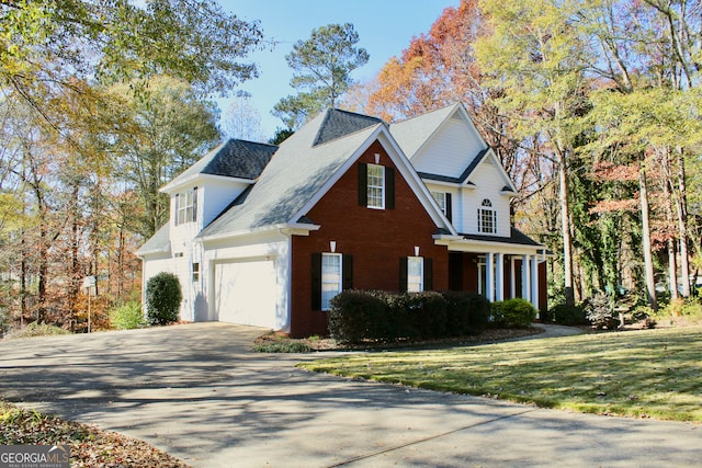 view of property featuring a garage and a front lawn