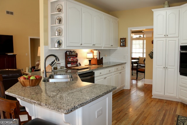 kitchen with white cabinets, dishwashing machine, and sink