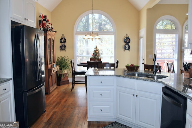 kitchen featuring white cabinetry, sink, dark hardwood / wood-style flooring, lofted ceiling, and black appliances