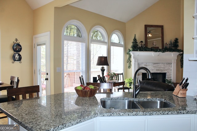 kitchen with vaulted ceiling, sink, and plenty of natural light