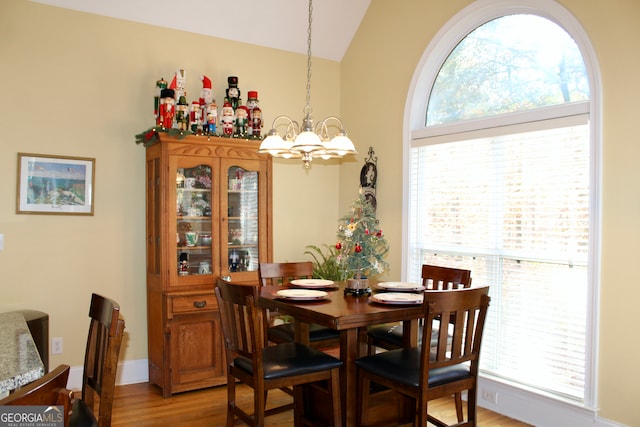 dining space with a chandelier, hardwood / wood-style flooring, and a wealth of natural light