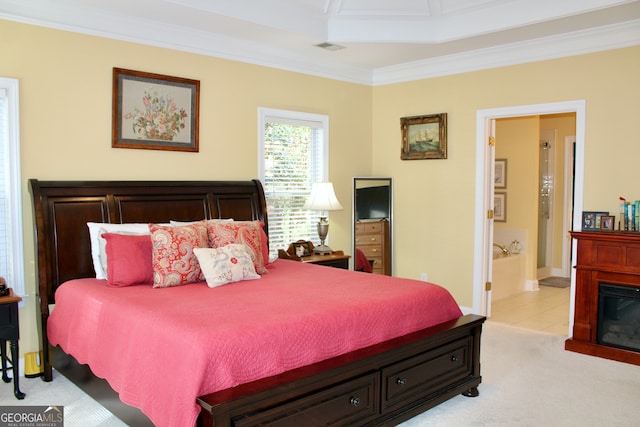 carpeted bedroom featuring crown molding and connected bathroom