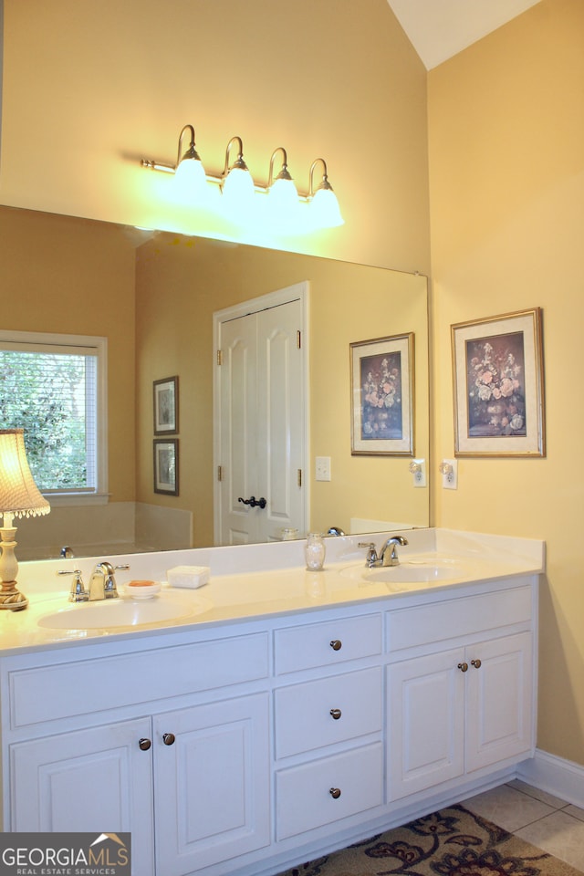 bathroom with tile patterned flooring and vanity