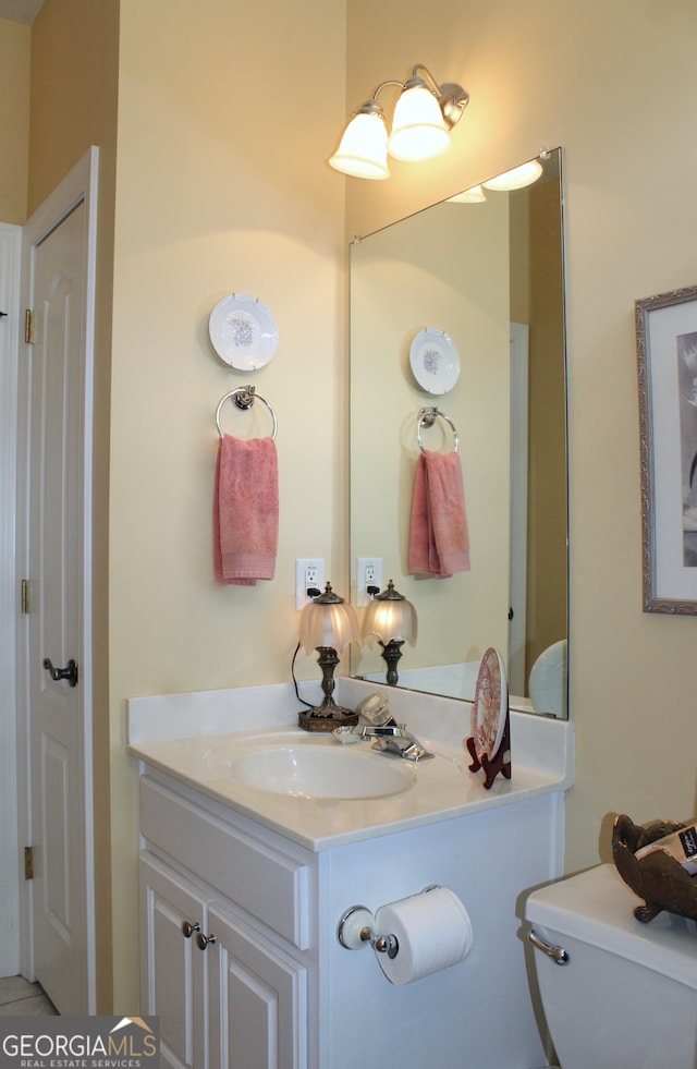 bathroom with vanity and toilet