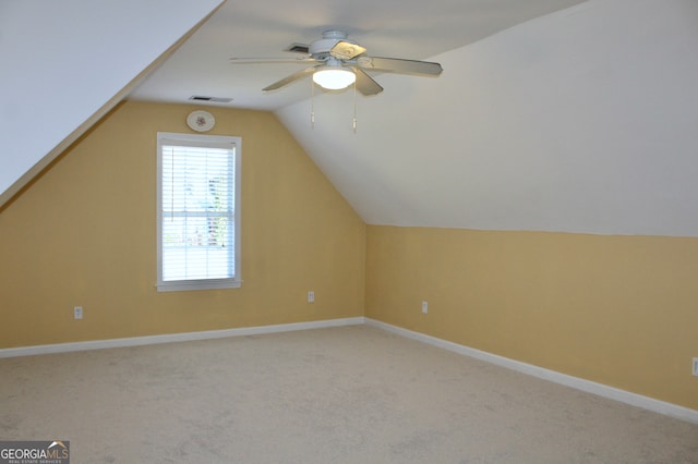 additional living space with carpet flooring, ceiling fan, and lofted ceiling