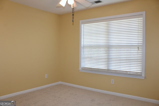 spare room featuring carpet floors and ceiling fan