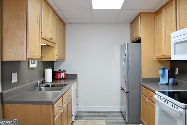 kitchen featuring light wood-type flooring, white appliances, sink, and light brown cabinetry