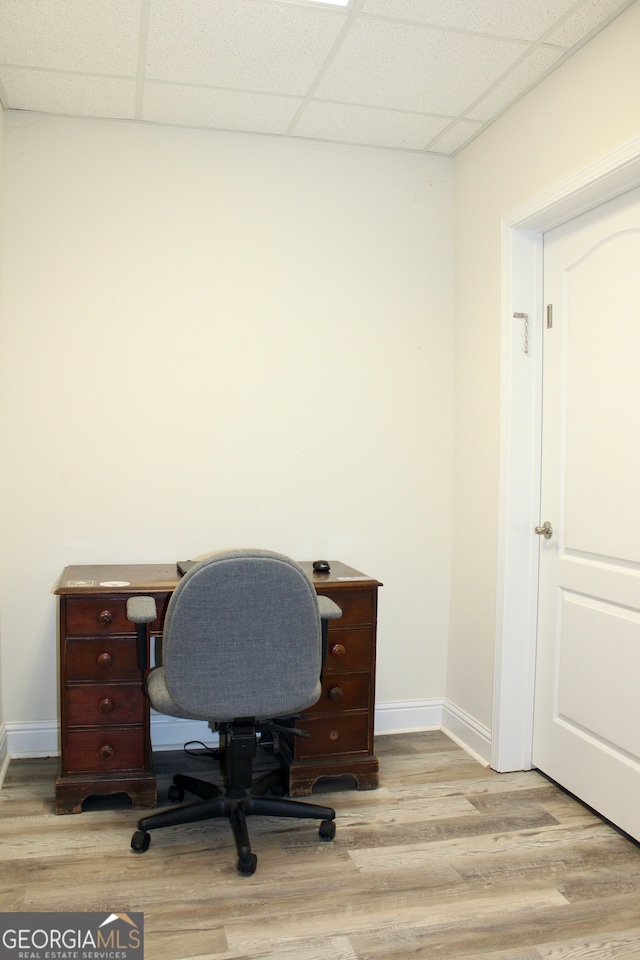 home office featuring light hardwood / wood-style floors and a drop ceiling