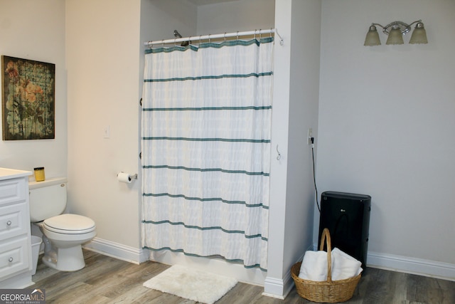 bathroom with hardwood / wood-style floors, vanity, toilet, and a shower with shower curtain