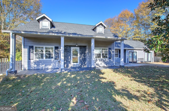 cape cod house featuring a front lawn