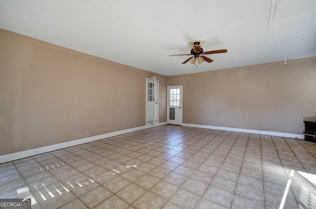 spare room with light tile patterned floors and ceiling fan