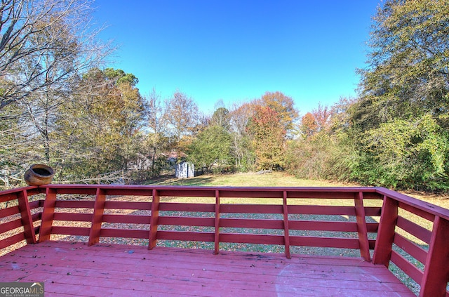 wooden deck featuring a storage shed